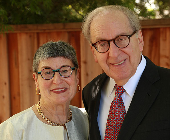 Judith and Lee Selwyn smile in an outdoor setting