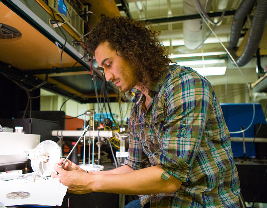 Graduate Student Matthew Nava works at a bench