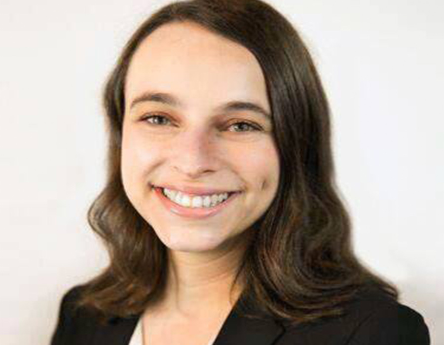 Chemistry major Jennifer Plotkin poses in front of a blank wall.