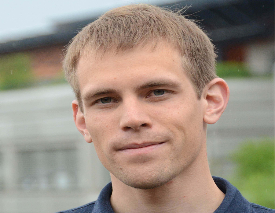 Postdoc Marcel Schreier poses in an outdoor setting.