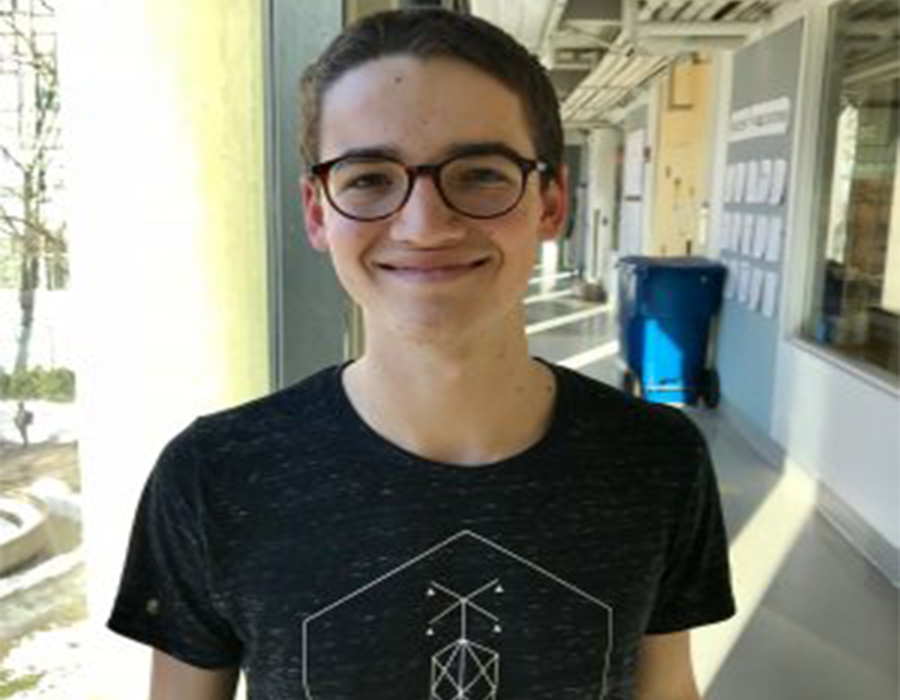 Chemistry Major Corin Wagen stands in the hall of Building 18