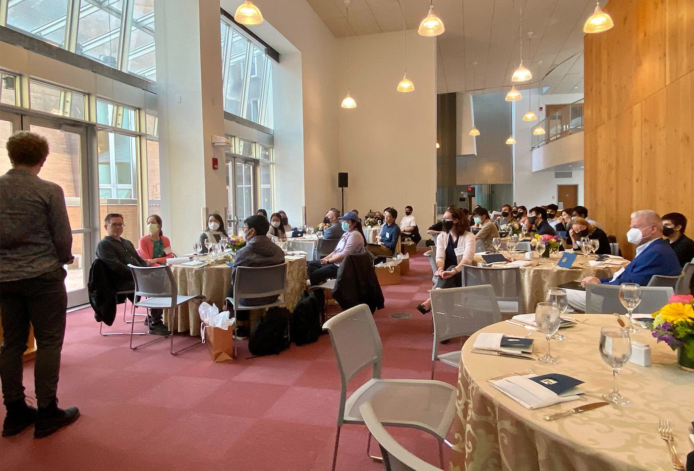 A banquet hall of people sitting at tables.