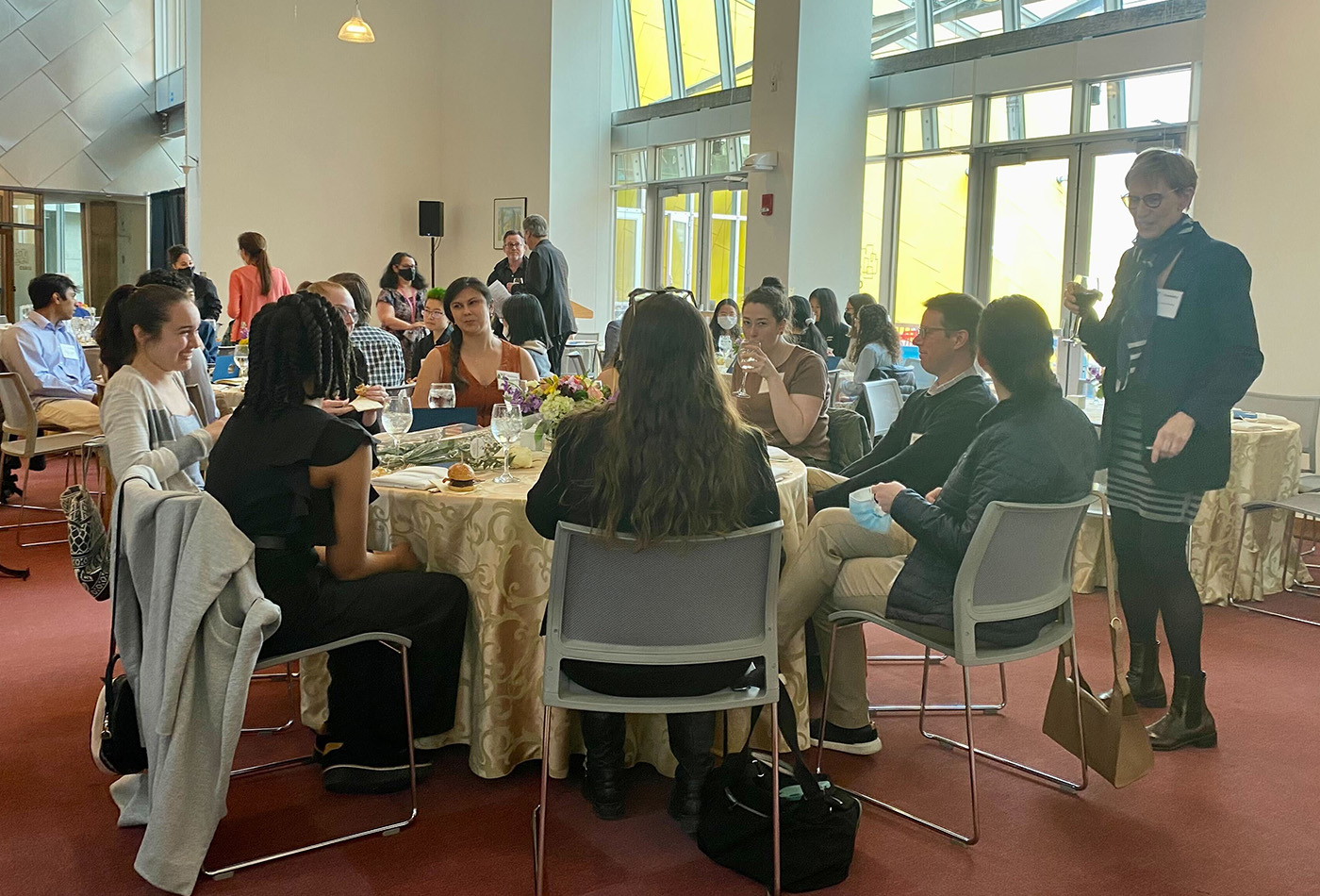 A banquet hall of people sitting at tables.