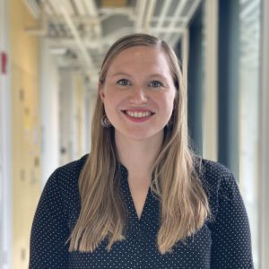 Jill Alty smiles in a corridor.