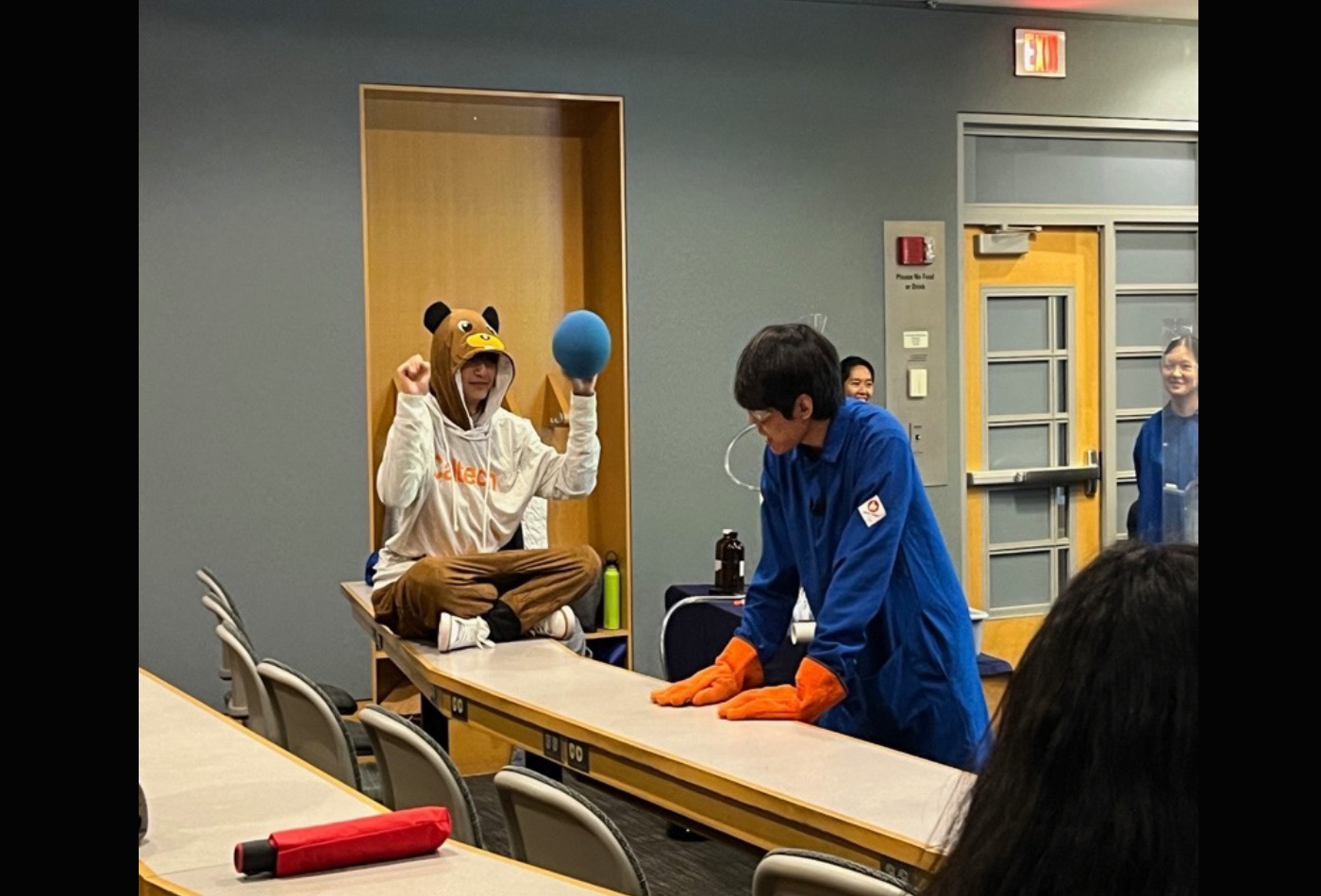 A group of students conduct magical experiments in a classroom.