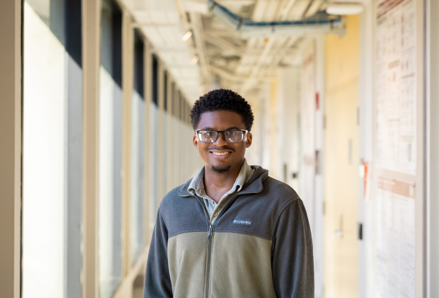 Gerasrd Porter stands in a corridor, smiling.